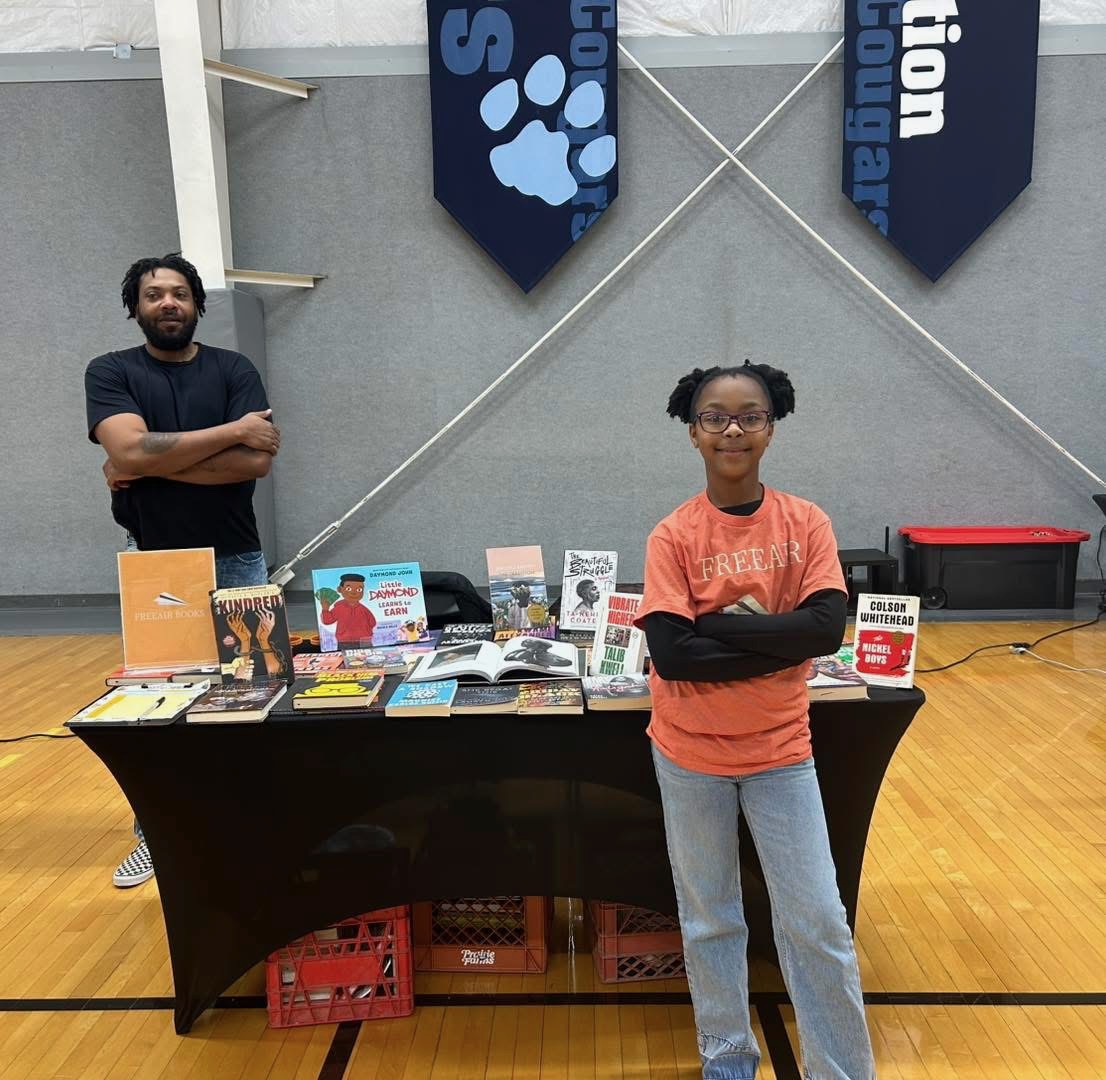 FREEAIR Books table with author at school event