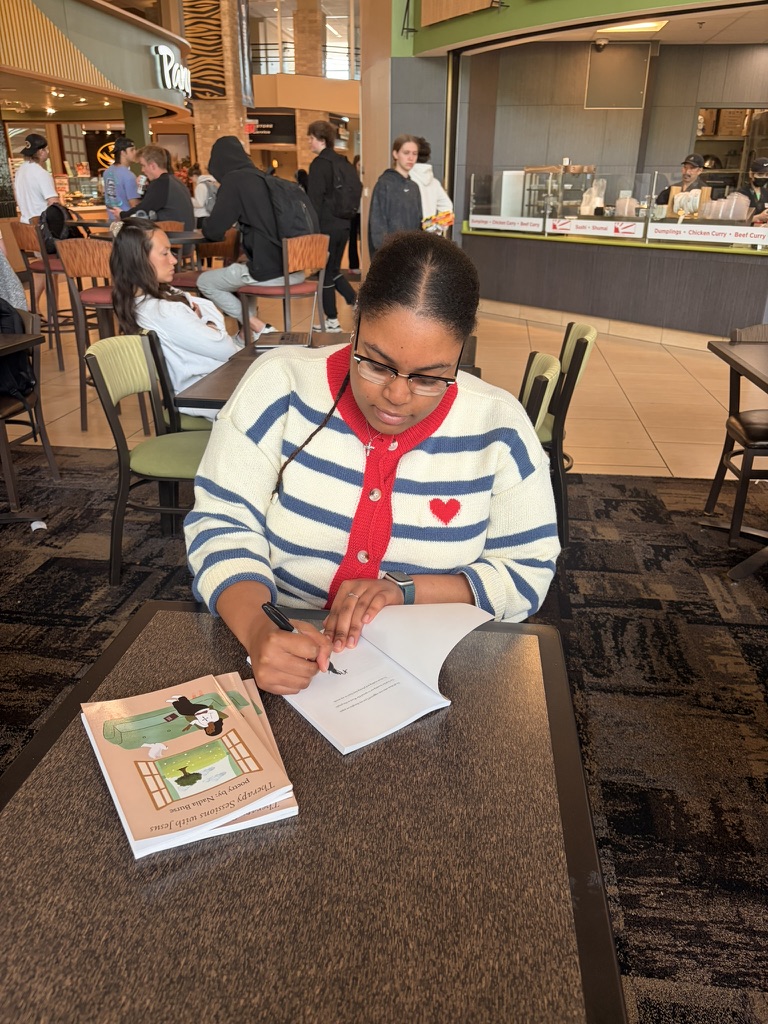 Nadia Burse signing copies of Therapy Sessions with Jesus